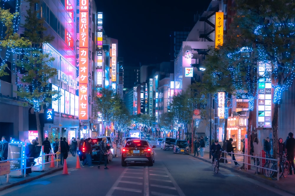 a busy city street at night with neon lights