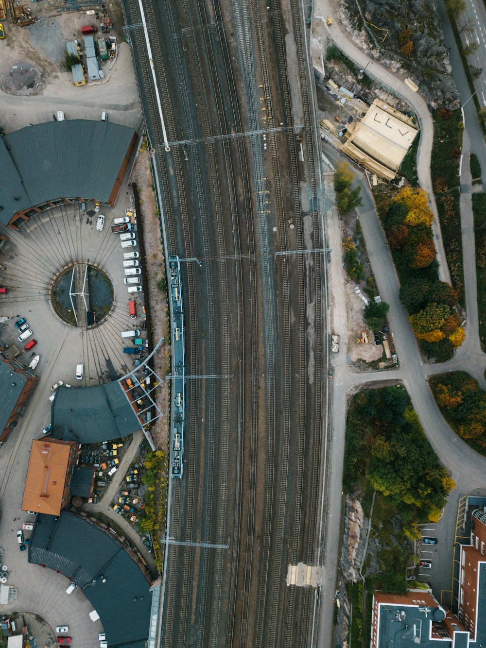 an aerial view of a city with a train track
