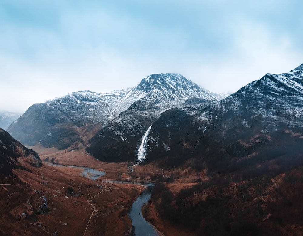 an aerial view of a mountain range with a river running through it