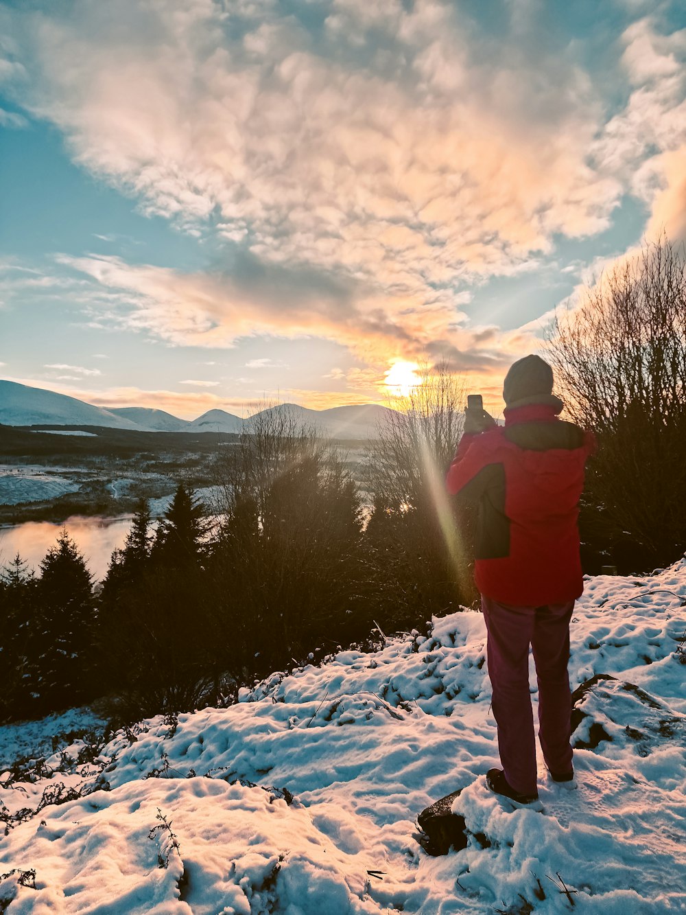 a person standing on top of a snow covered hill