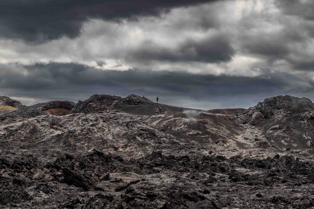 a mountain range under a cloudy sky