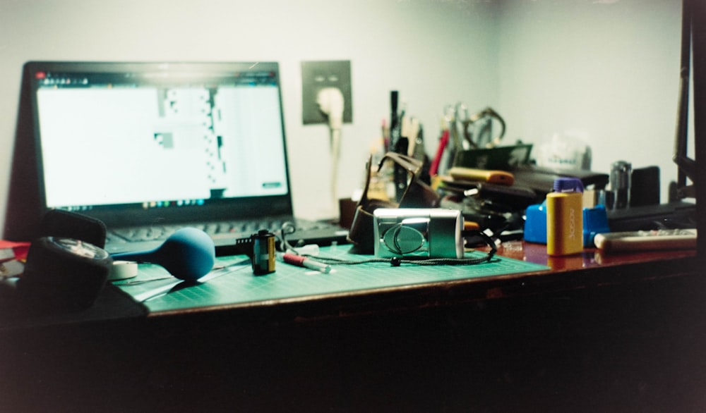 a laptop computer sitting on top of a wooden desk