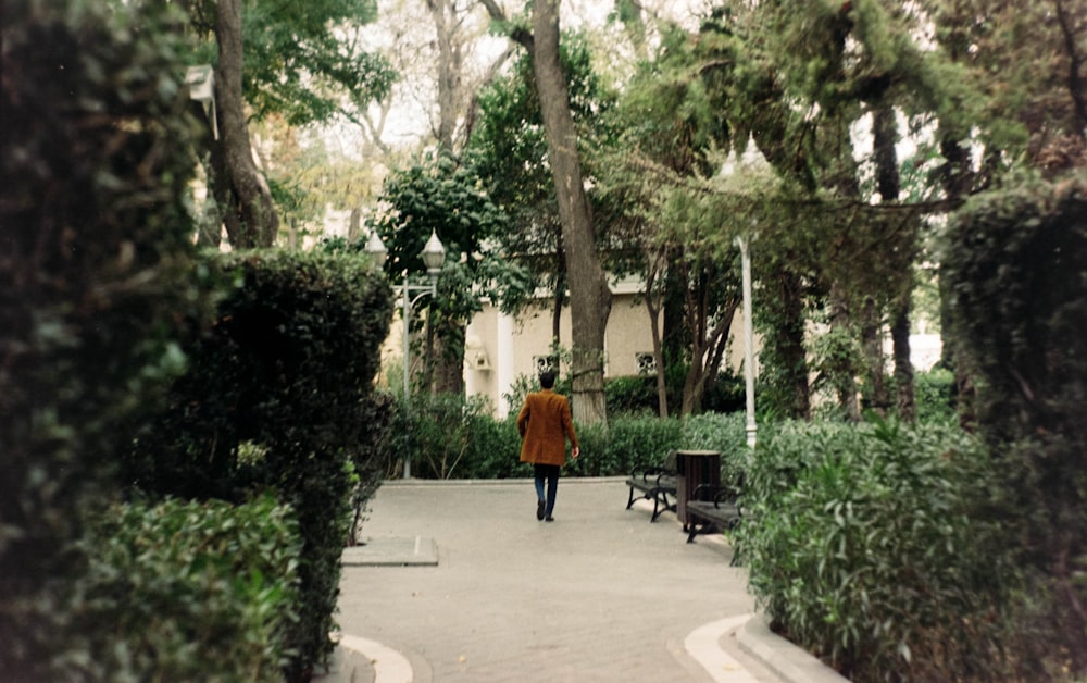 a person walking down a path in a park