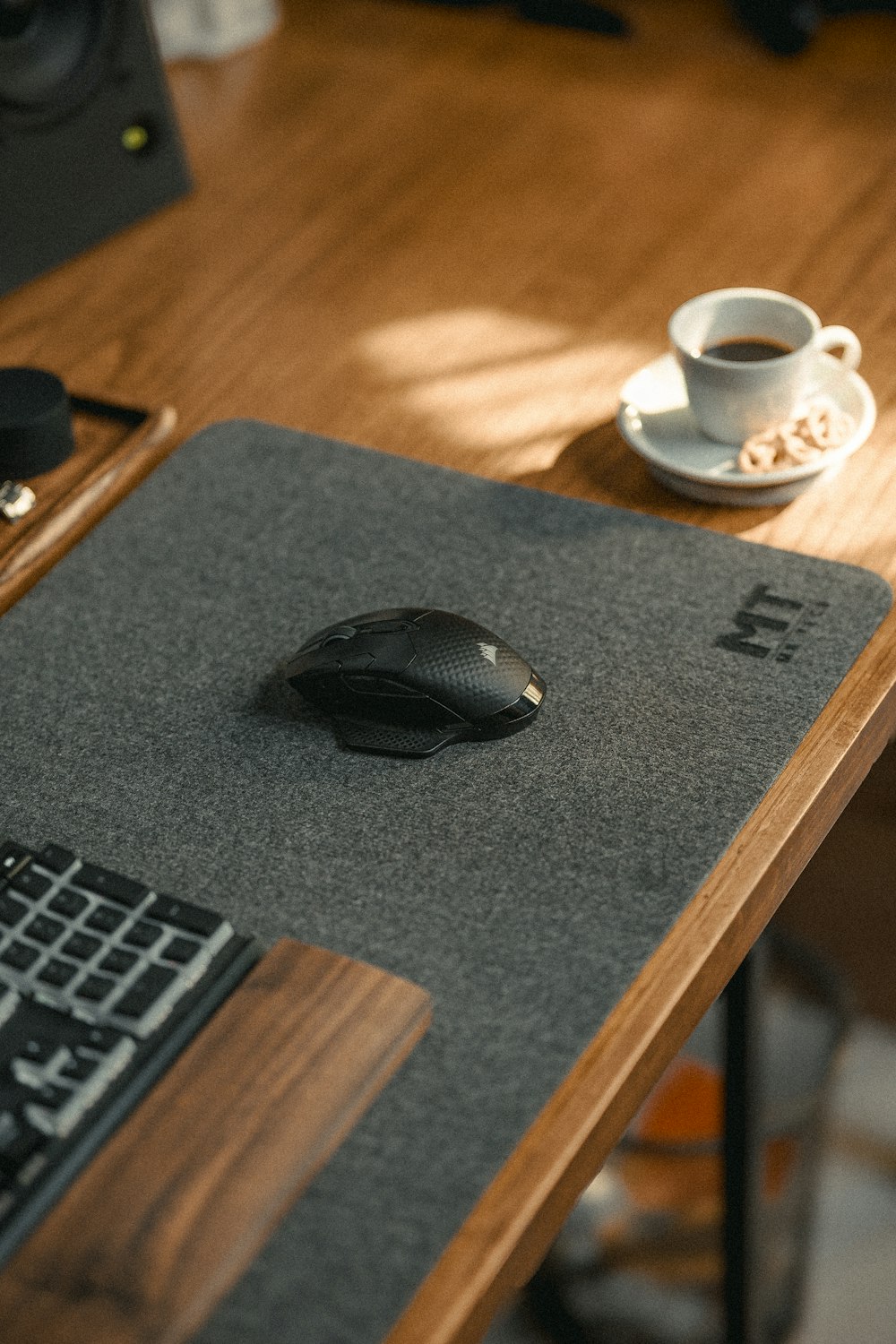 a mouse pad sitting on top of a wooden desk