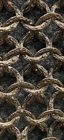 A close-up of intricate scale maille detailing on a costume.