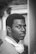 A young Zimbabwean man listening intently to an interview on Diaspora Files Global via headphones.