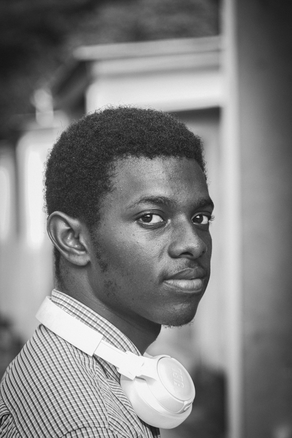 a black and white photo of a man wearing headphones