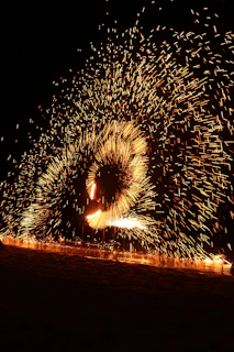 A mesmerizing spinning stick creating a vibrant, colorful image in mid-air at an event.