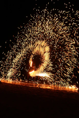 A mesmerizing spinning stick creating a vibrant, colorful image in mid-air at an event.