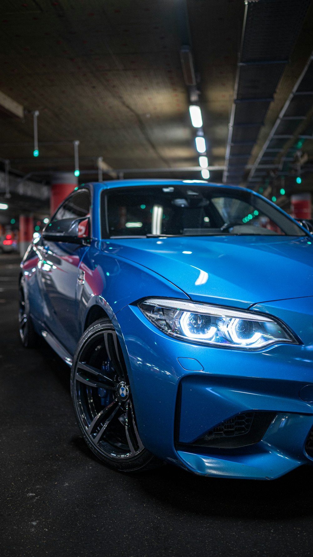 a blue car parked in a parking garage