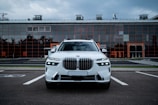 a white bmw X7 suv parked in a parking lot
