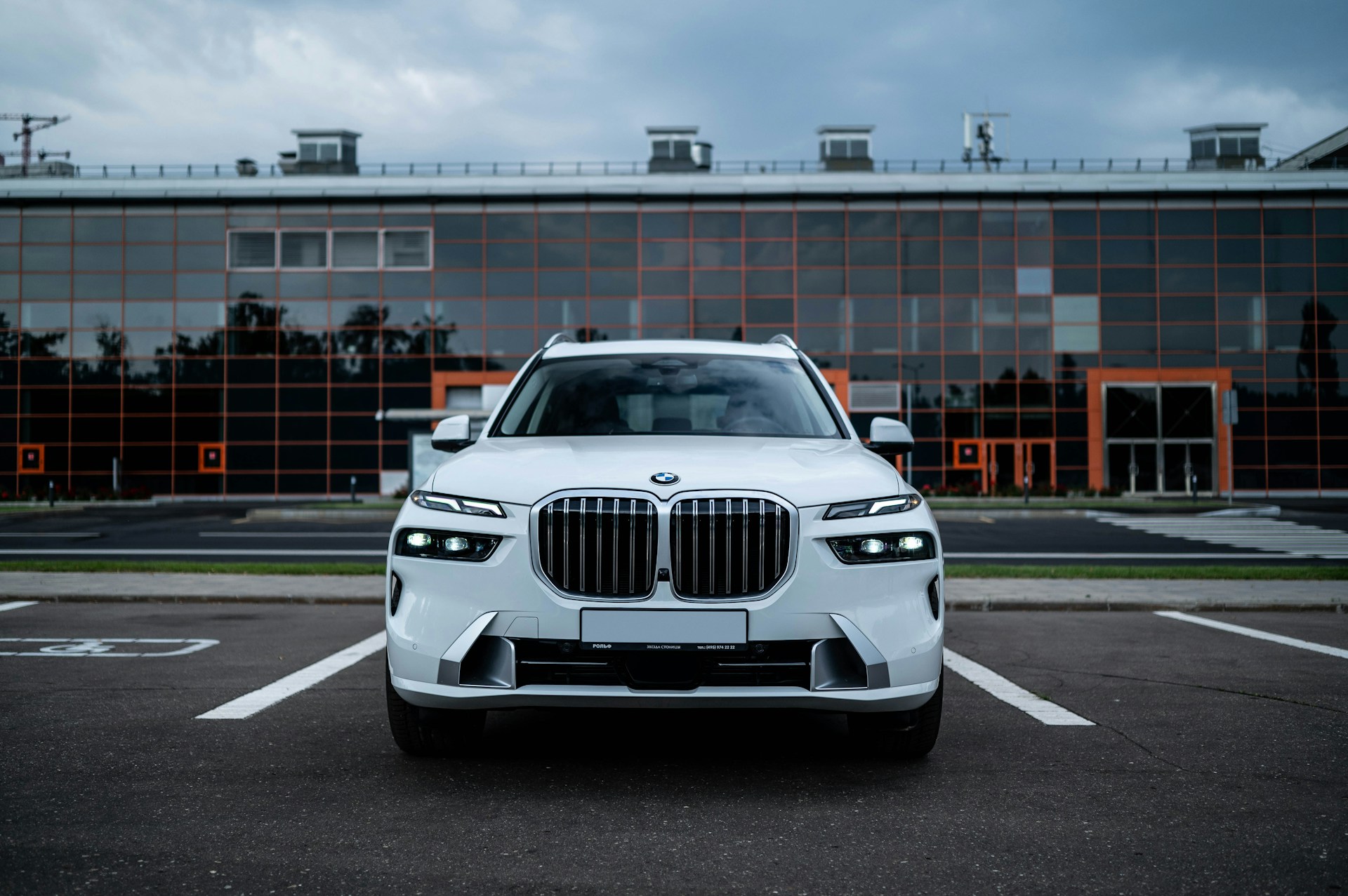 a white bmw suv parked in a parking lot
