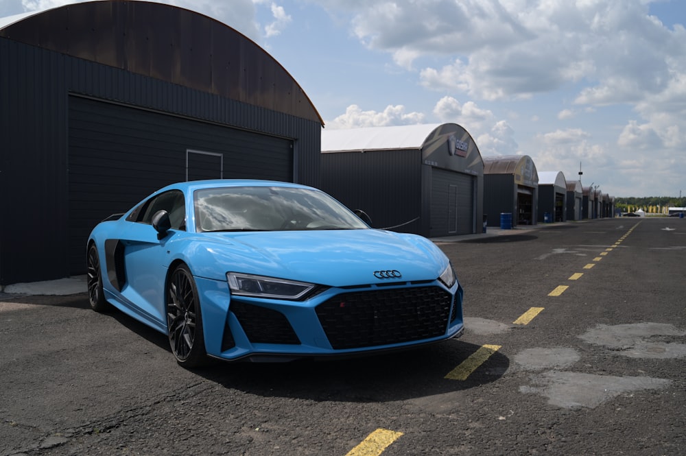 a blue car parked in front of a building