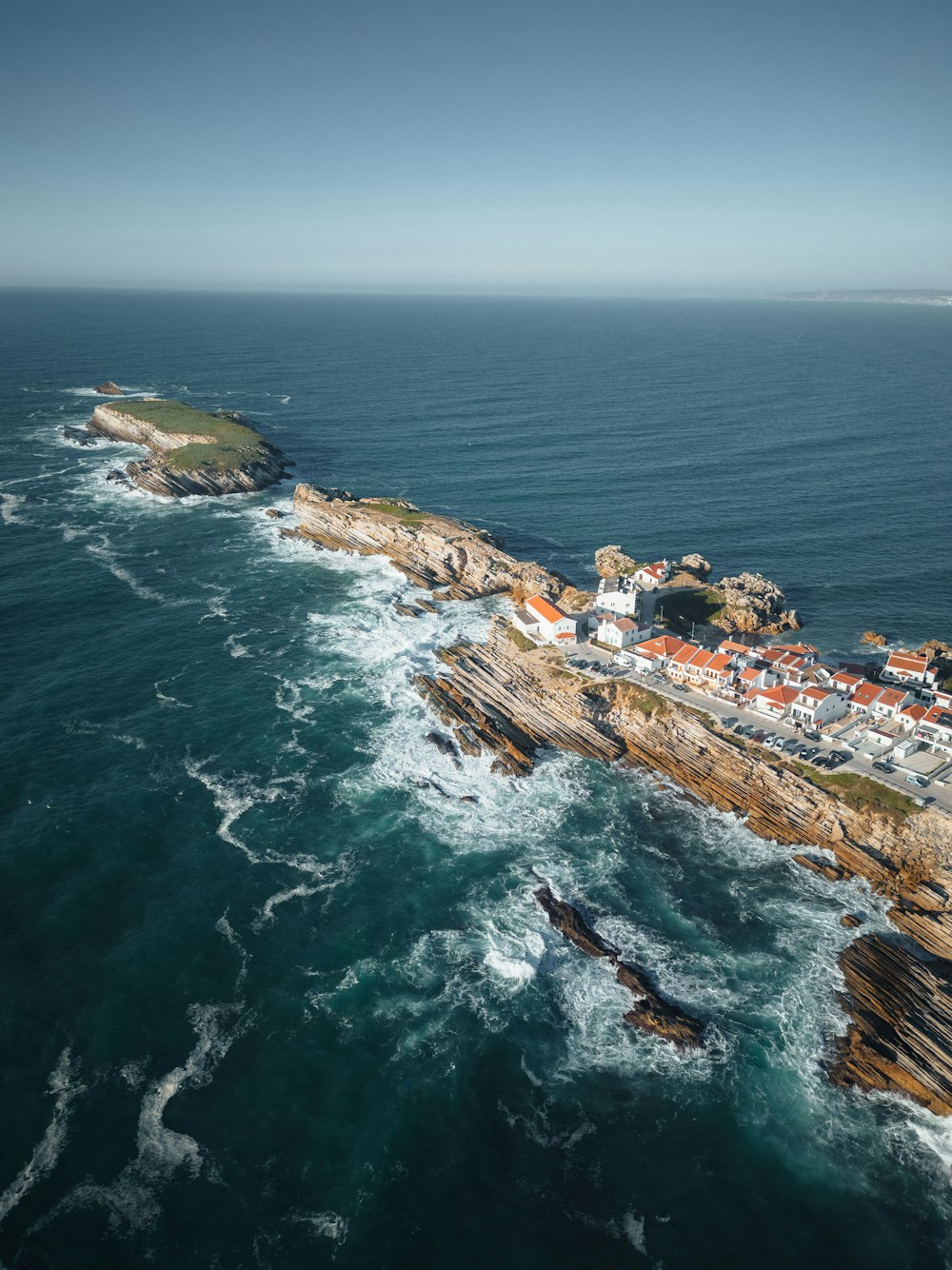 an aerial view of a small town on the coast