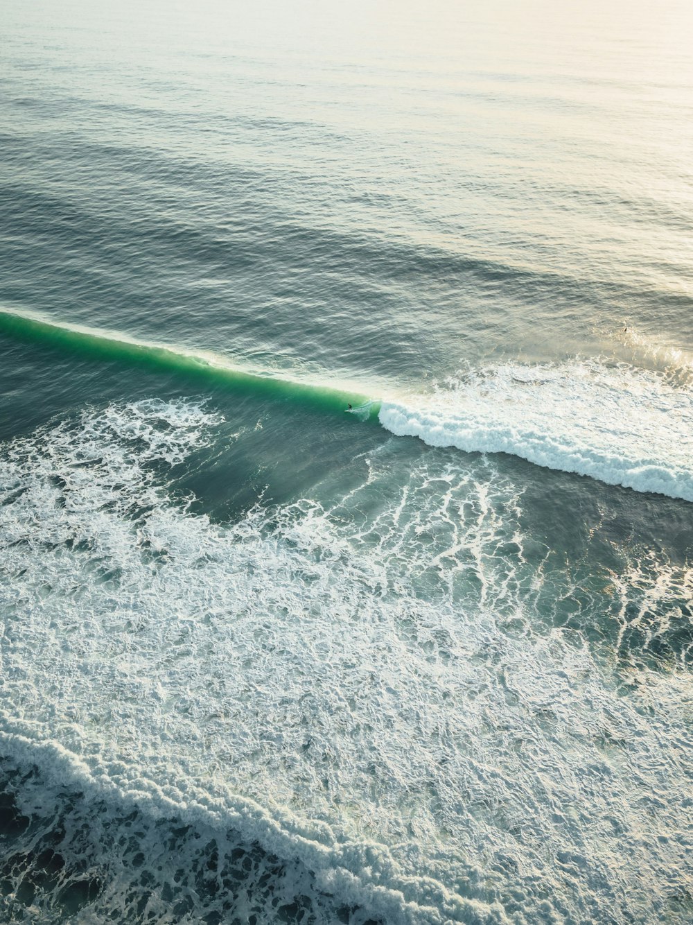 a man riding a wave on top of a surfboard