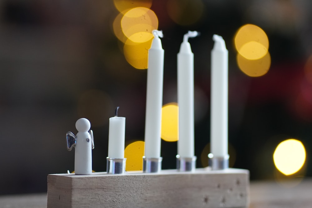 a group of candles sitting on top of a wooden block