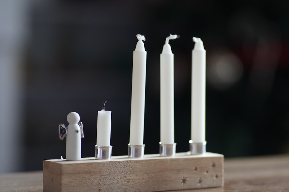 a group of candles sitting on top of a wooden block