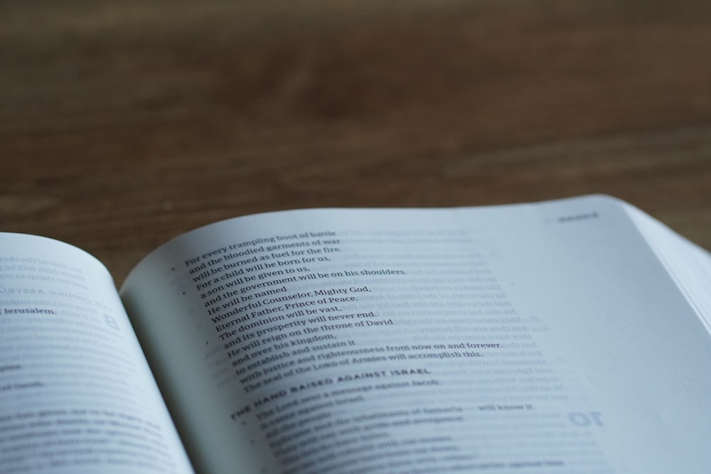 an open book sitting on top of a wooden table