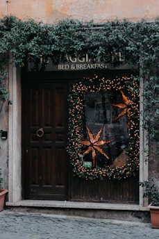 A friendly concierge welcoming guests at a cozy holiday rental entrance.