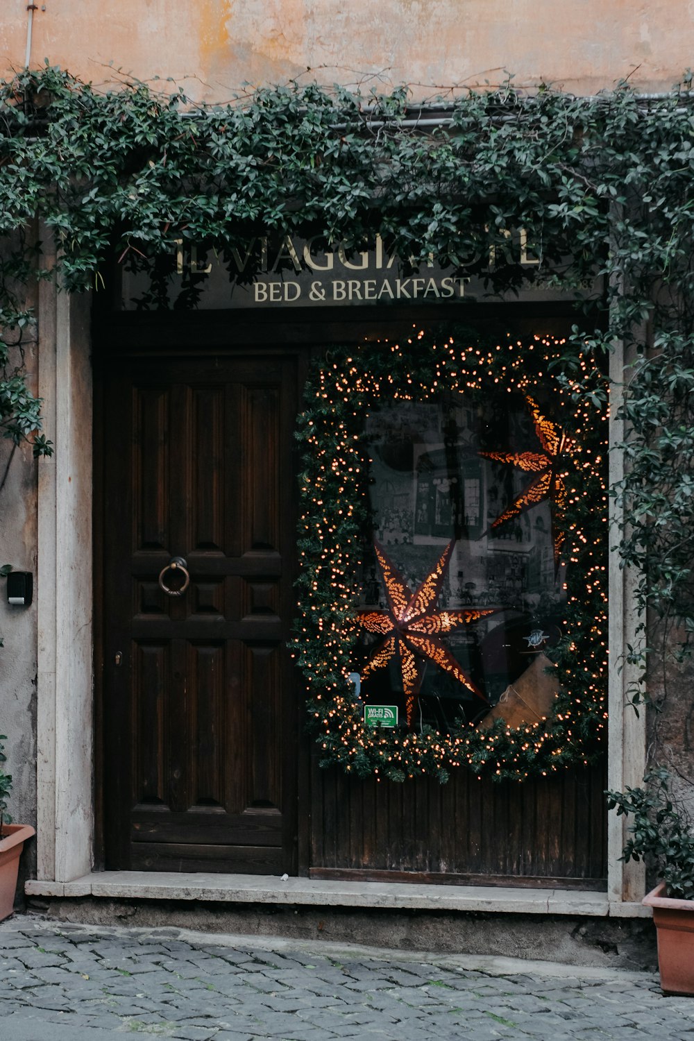 a starfish wreath on the front door of a bed and breakfast