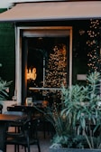 A cozy café with outdoor seating and colorful decorations.