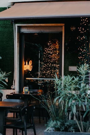 A cozy café with outdoor seating and colorful decorations.