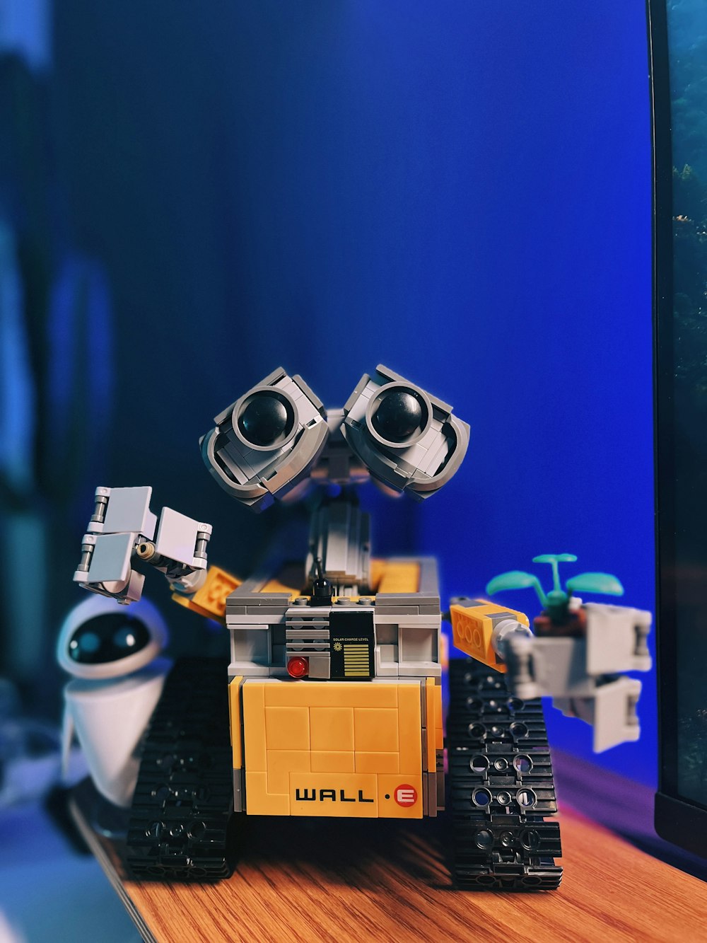 a small robot sitting on top of a wooden table