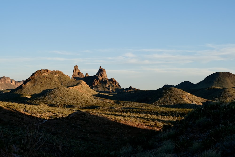 a group of mountains in the distance with a blue sky