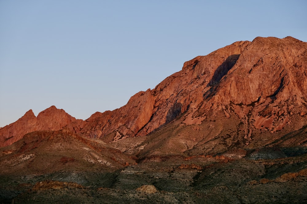 a large mountain with a sky background