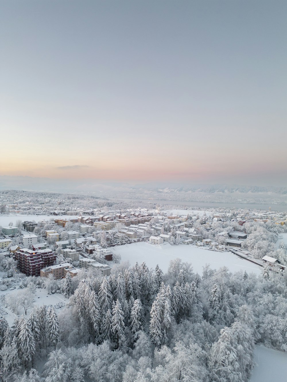 an aerial view of a snow covered city