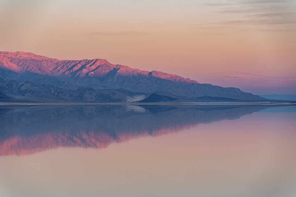 a large body of water with mountains in the background