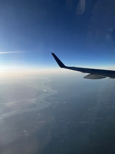 A scenic view from an airplane window during a spontaneous trip.