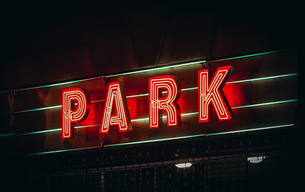 a neon sign that says park on the side of a building