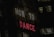 A neon sign with the words 'HOW TO' in white and 'DANCE' in red, set against a dark urban backdrop. Windows of a nearby building are visible in the background.