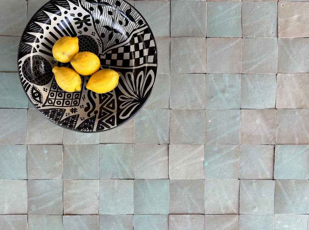 a black and white plate with lemons on it