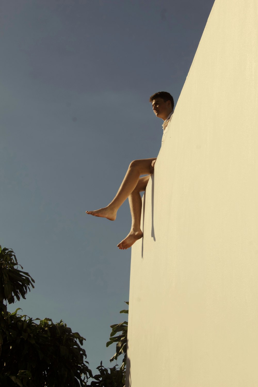 a woman is sitting on the side of a building