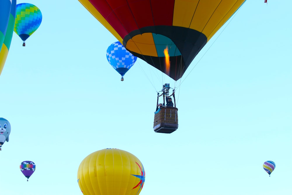 a bunch of hot air balloons flying in the sky