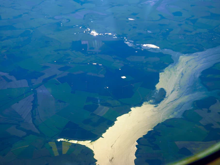 A panoramic view of the five rivers flowing through lush green fields in Punjab.
