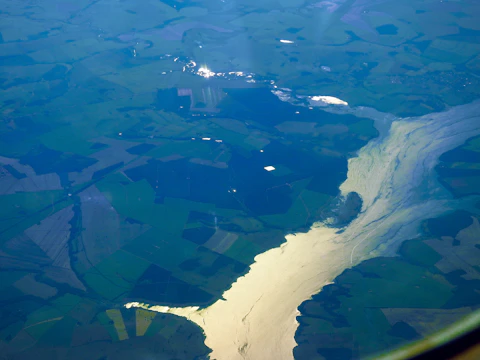 A panoramic view of the five rivers flowing through lush green fields in Punjab.