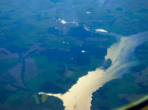 A vibrant aerial view of the five rivers flowing through lush Punjab farmland.