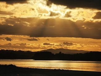 A serene landscape with sunlight breaking through clouds, symbolizing hope and guidance.