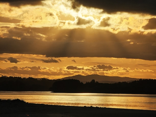 A serene landscape with sunlight breaking through clouds, symbolizing hope and guidance.