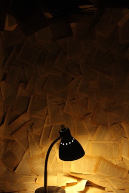 A chaotic office room with scattered papers and glowing warm orange accents.