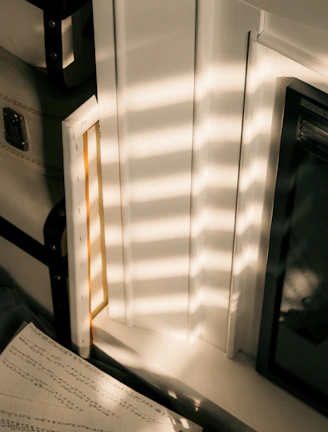 Sunlight streaming through a window illuminating a collection of finished artworks.