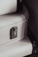 Close-up of reinforced hardware and sturdy zippers on a black carry-on bag.