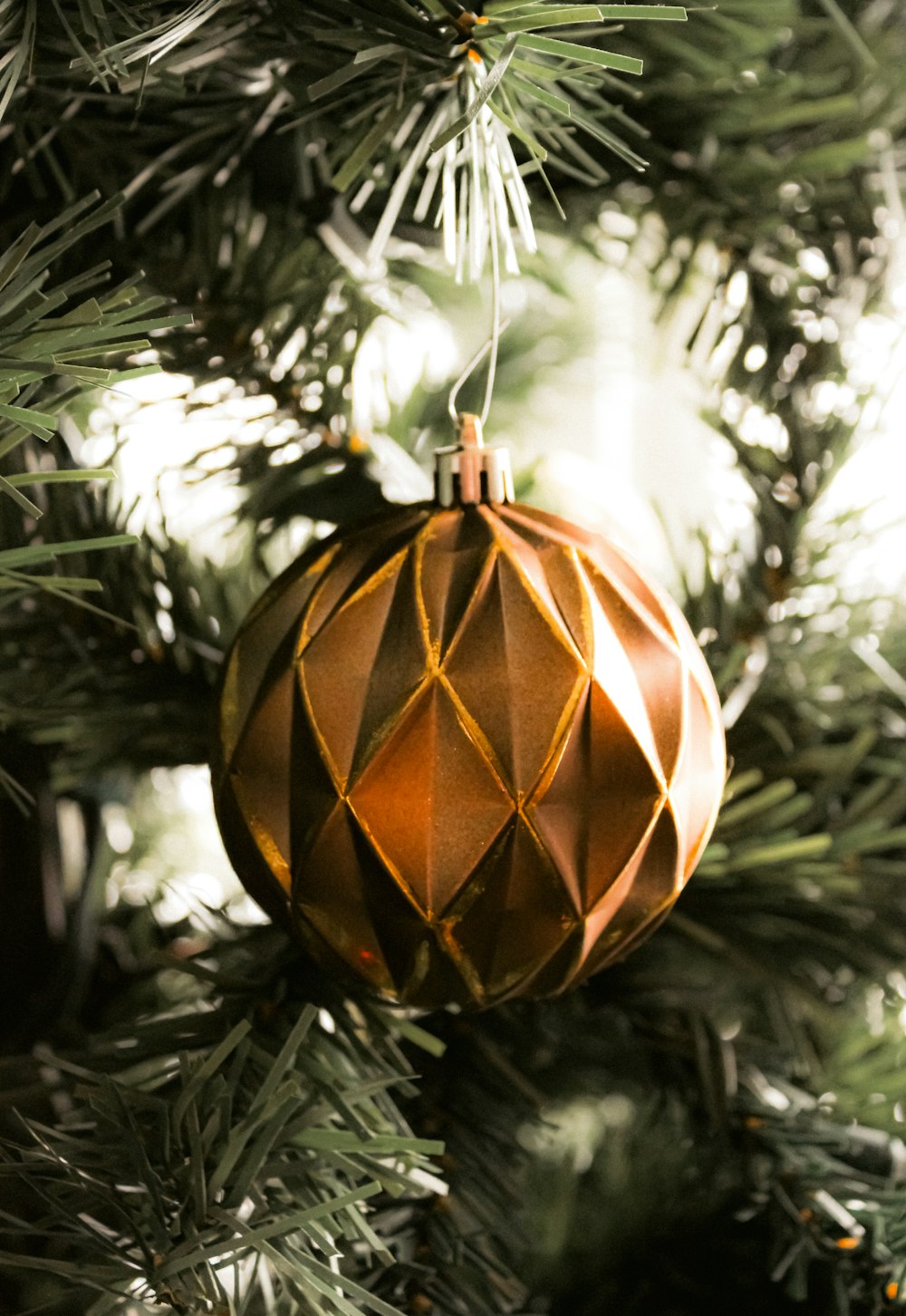 a brown ornament hanging from a christmas tree