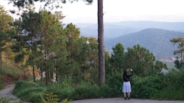 An influencer creating content outdoors, surrounded by nature and vibrant scenery.