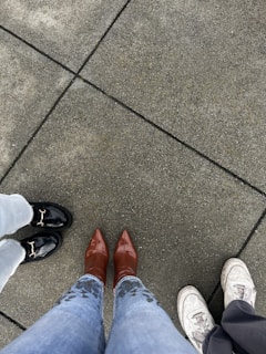 a couple of people standing on top of a sidewalk