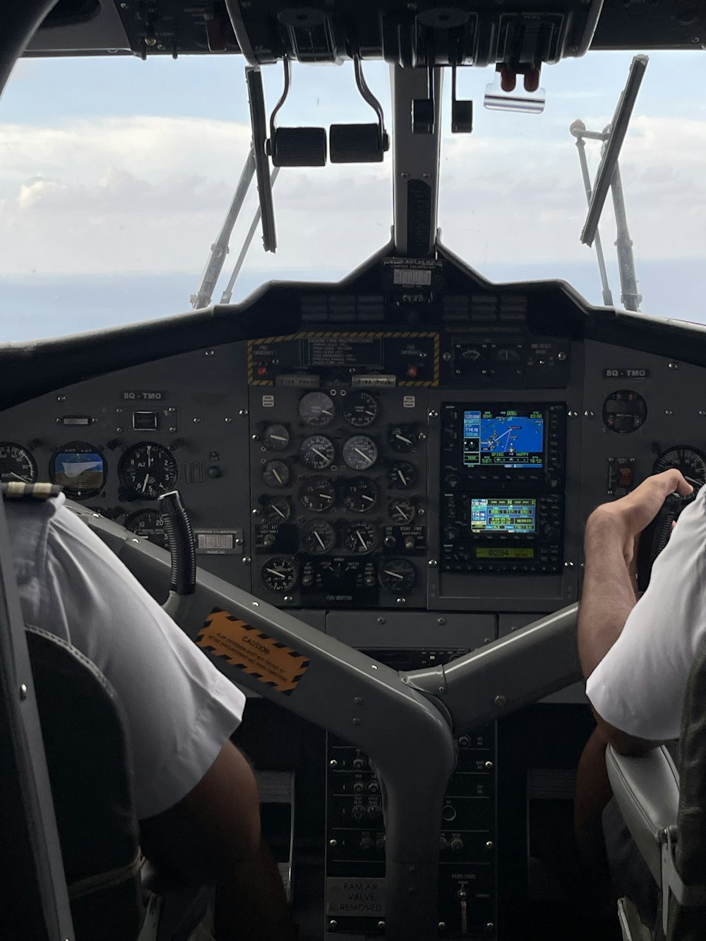 two pilots in the cockpit of a plane