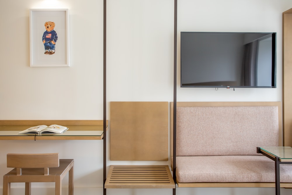 a living room with a television and a desk